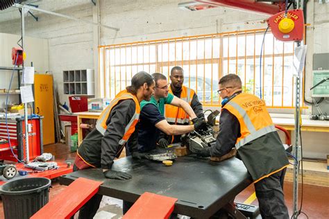 Photo d'un atelier de réparation de quads avec des mécaniciens travaillant sur un véhicule