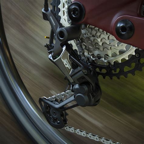 Vue éclatée d'un dérailleur arrière Shimano VTT, mettant en évidence le mécanisme de friction.