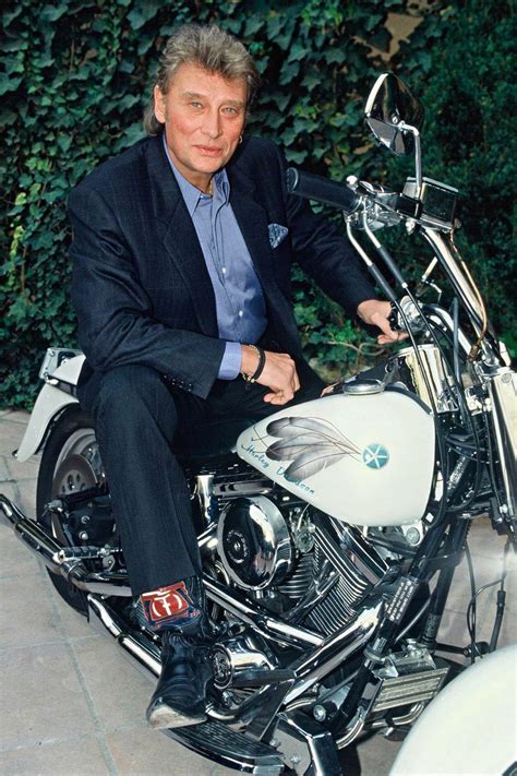 Photographie de Johnny Hallyday en 1977, posant avec une Harley-Davidson XLCR 1000.