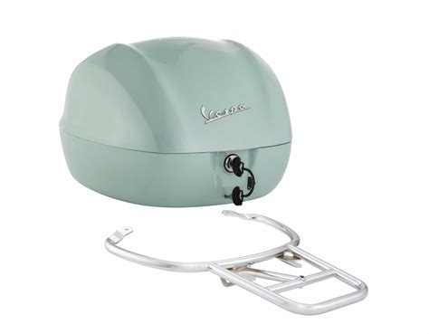 Vue éclatée du top case Vespa Primavera, montrant le top case lui-même, le support et les points de fixation.