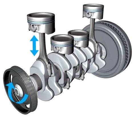 Un assemblage de pièces de moteur de cyclomoteur, incluant un vilebrequin et des pistons, dans un atelier