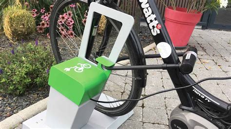 Panneau indiquant un parking à vélos et une borne de recharge pour VAE à Le Perrier