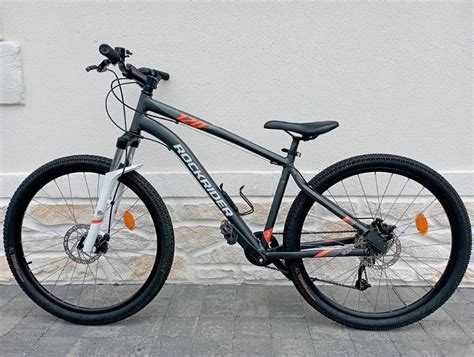 Photo du VTT Rockrider ST 120 avec un cycliste sur un sentier.