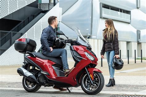 Vue d'ensemble de différents modèles de scooters Peugeot, incluant des Kisbee, Pulsion et Metropolis, disposés dans un showroom.