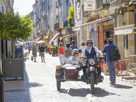 Photo d'un couple souriant dans un side-car moderne lors d'une balade ensoleillée